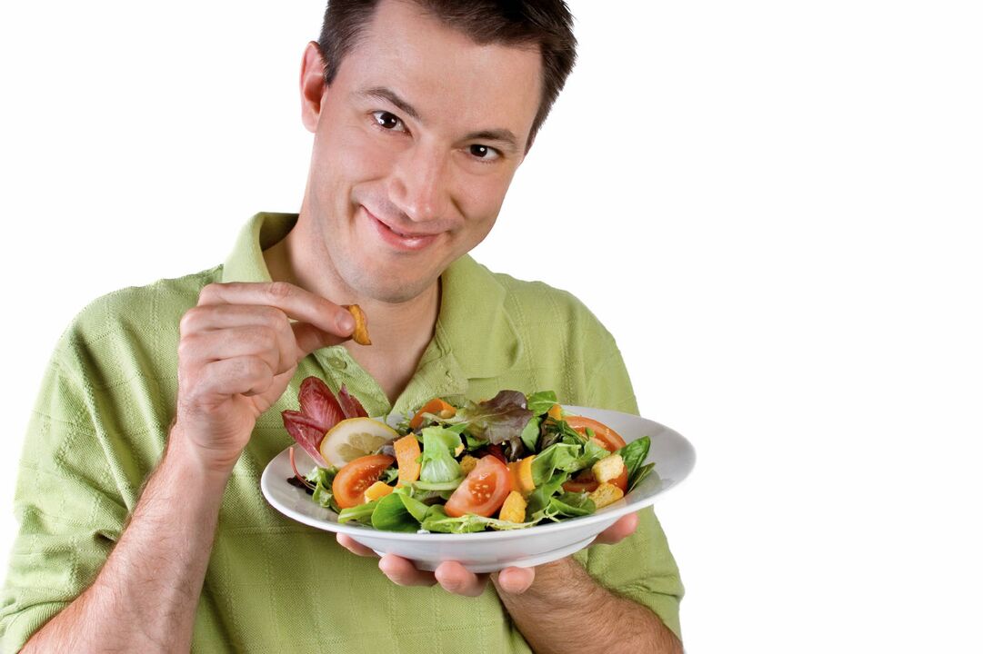 man eats vegetable salad for activity