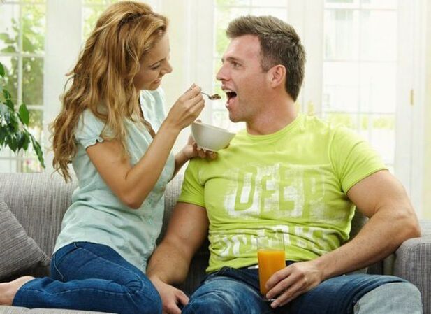 a woman feeds a man with products to increase power